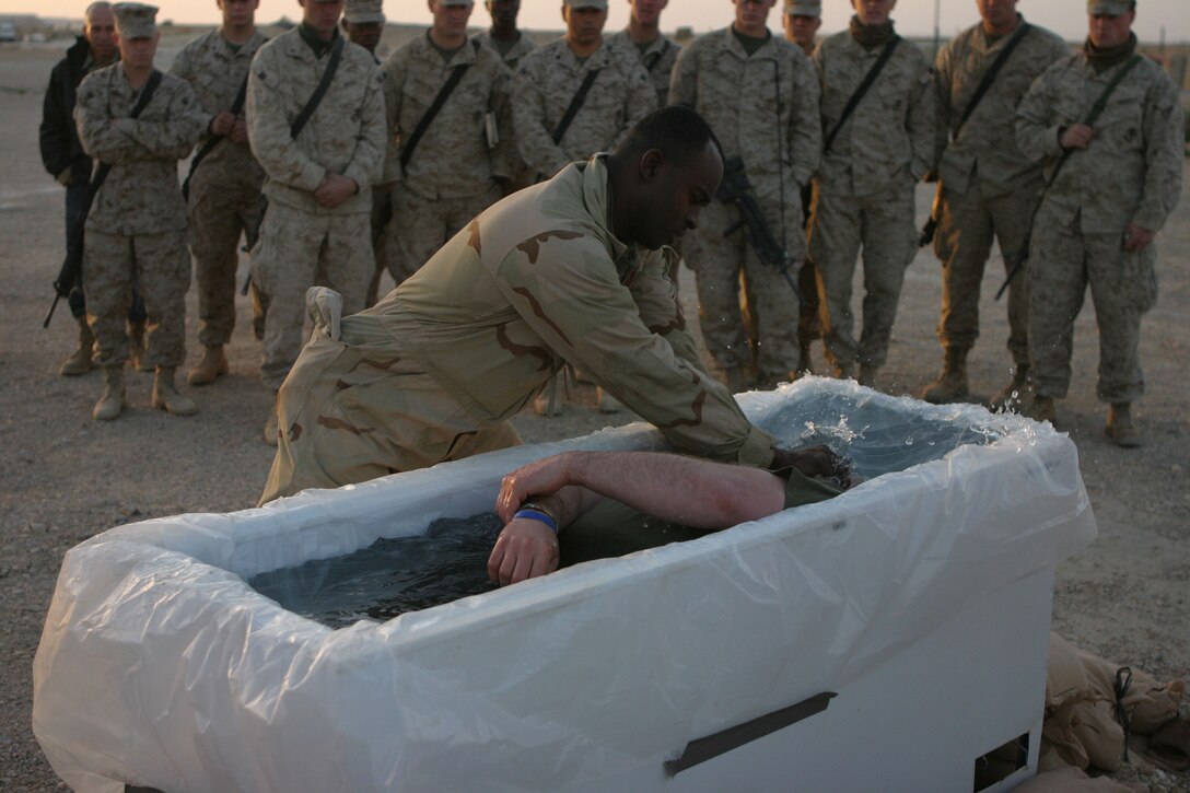 CAMP AL QA'IM, Iraq (March 27, 2005)- Cpl. Robert B. Sherman, 32, a supply clerk with 3rd Battalion, 2nd Marine Regiment is baptized by fellow noncommissioned officer Sgt. Kendrick L. Mc Rae here at sunrise Easter Sunday. Sherman, a Erlanger, Ky., native decided he would make a public announcement of his faith and be baptized in front of his fellow Marines in Iraq. Sherman graduated from Heights High School in 1990 and Georgetown College in 1994, Official U.S. Marine Corps photo by Lance Cpl. Lucian Friel (RELEASED)