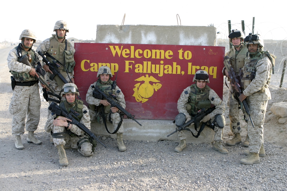 CAMP BAHARIA, Iraq - First Battalion, Sixth Marine Regiment's civil affairs team, Team 3, Detachment 2, 5th Civil Affairs Group, poses for a group photo at nearby Camp Fallujah.  The unit travels around the Fallujah area assessing the needs of the population and determining how they may best be helped.