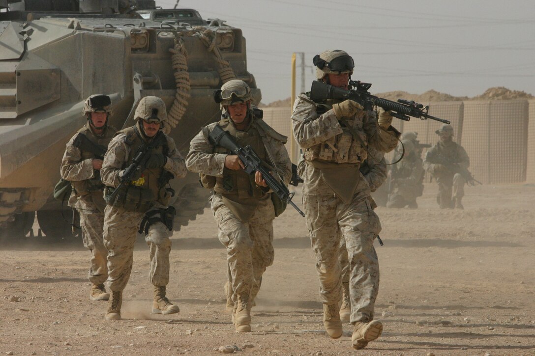 CAMP AL QA'IM, Iraq (April 1, 2005)- Cpl. Richard C. Marshall, the 1st squad leader with 1st Platoon, Company K, 3rd Battalion, 2nd Marine Regiment leads his squad in rehearsals for the raid that took place in Sedah April 4. The Marines of Kilo Co. took seven detainees during the raid including their main target, who was a known exposives expert. Marshall, a native of Denver, considered the mission to be a complete success. Official U.S. Marine Corps photo by Lance Cpl. Lucian Friel (RELEASED)