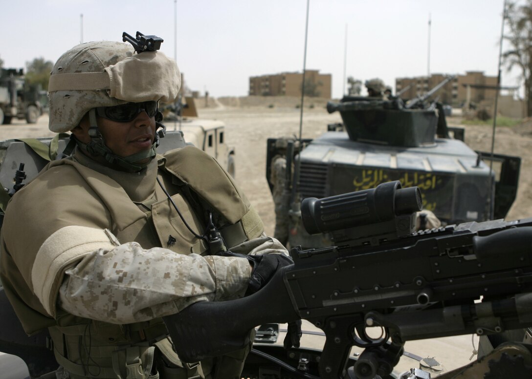 FALLUJAH, Iraq - Cpl. Jorge Granados, vehicle gunner with 1st Battalion, 6th Marine Regiment's Personal Security Detail Platoon, rests behind his machine gun turret when his convoy stops to drop off some passengers.  PSD performs missions such as escorting the battalion commander throughout the city, working alongside infantry companies to conduct raids, and patrolling Fallujah's streets in search of insurgent activity.