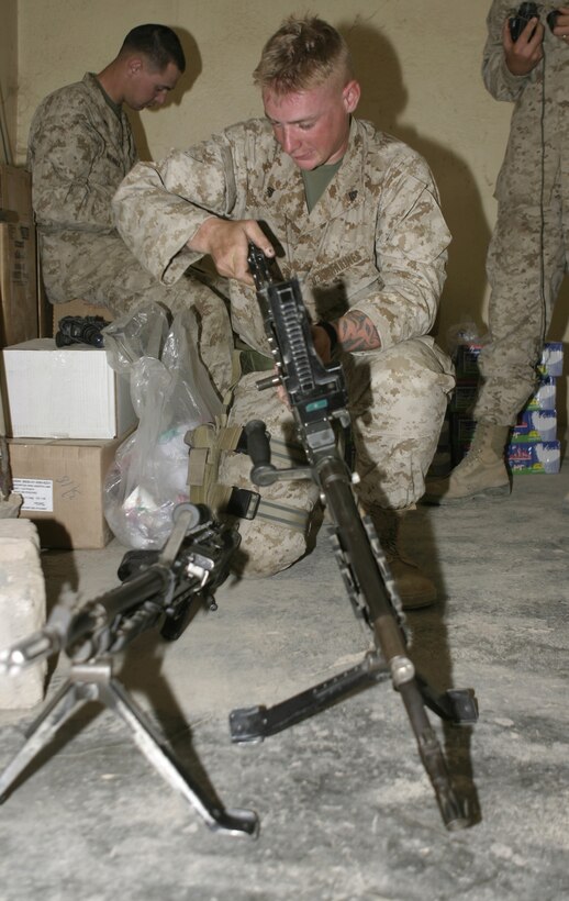 FALLUJAH, Iraq - . Daniel K. Jones, small arms technician with 1st Battalion, 6th Marine Regiment, inspects an M240G medium machinegun during a visit to Company B's, 1st Battalion, 6th Marine Regiment base of operations here April 8.  Jones and fellow technicians offer their services as part of the 'XO's Road Show,' a Headquarters and Service Company convoy that travels once a week to the battalion's infantry companies' bases in Fallujah to offer the grunts services such as motor transport and communications equipment repair, religious services, and administrative and legal support.