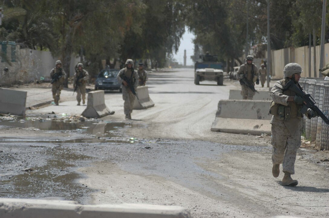 AR RAMADI, Iraq (April 11, 2005) - Marines with 2nd Squad, 1st Platoon, Company A, 1st Battalion, 5th Marine Regiment, return to the confines of the Government Center Observation Post after conducting an aggressive foot patrol through the city here.Leathernecks with 2nd Squad, 1st Platoon, Company A, 1st Battalion, 5th Marines, have become familiar with their area of operations where they conduct security and stability operations almost daily. They've learned to recognize landmarks to help determine what particular street they're patrolling. First Battalion, 5th Marines are two months into their seven-month deployment here in support of Operation Iraqi Freedom. Photo by Cpl. Tom Sloan