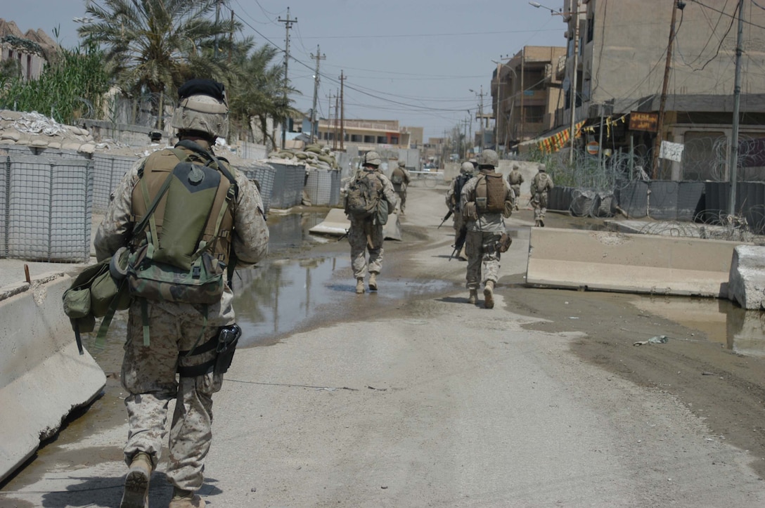 AR RAMADI, Iraq (April 11, 2005) - Marines with 2nd Squad, 1st Platoon, Company A, 1st Battalion, 5th Marine Regiment, return to the confines of the Government Center Observation Post after conducting an aggressive foot patrol through the city here. Leathernecks with 2nd Squad, 1st Platoon, Company A, 1st Battalion, 5th Marines, have become familiar with their area of operations where they conduct security and stability operations almost daily. They've learned to recognize landmarks to help determine what particular street they're patrolling. First Battalion, 5th Marines are two months into their seven-month deployment here in support of Operation Iraqi Freedom. Photo by Cpl. Tom Sloan