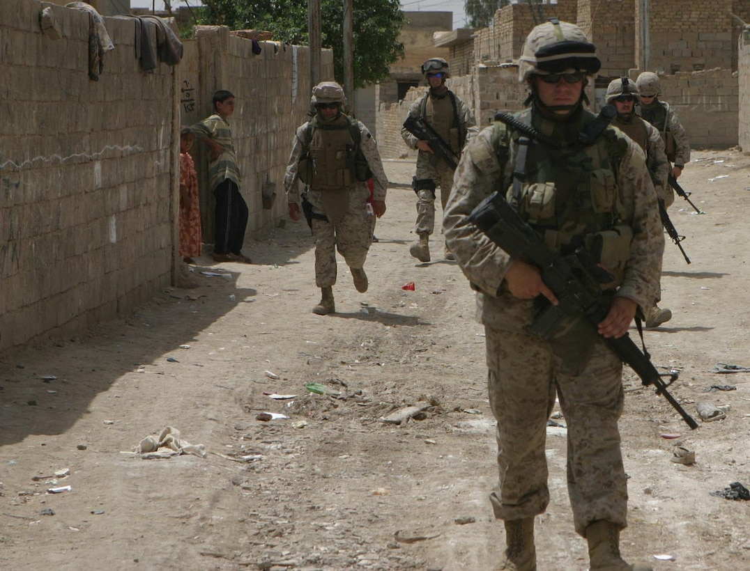 CAMP DELTA, IRAQ -- Lance Cpl. John E. Fleming, a Motor Transportation Operator working with the Civil Affairs Group, and Salsbury, Md., native is part of the security when CAG goes out into the cities.  Official U.S. Marine Corps photo by Lance Cpl. Athanasios L. Genos