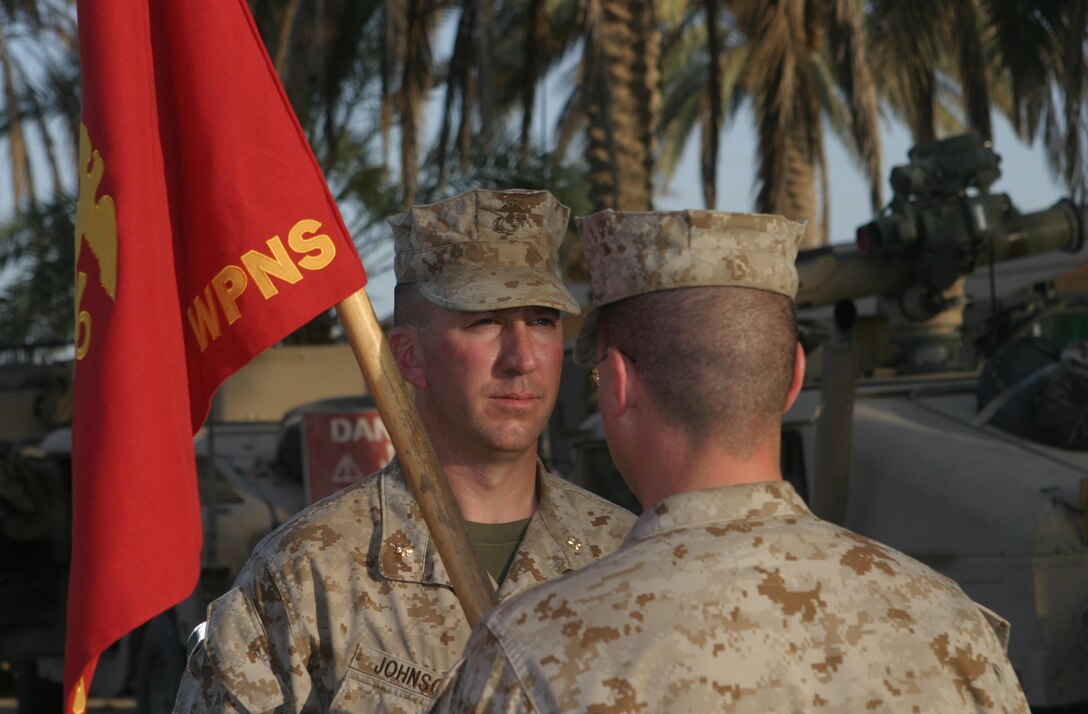 Al Anbar Province, Iraq (May 21, 2005) Capt. Sean K. Butler from Mount Shasta, CA, of Weapons Co(Wpns Co), 3rd Battalion, 4th Marine Regiment (3/4) takes the Company guidon during the Change of Command ceremony for Wpns Co. The Marines with 3/4, part of 2nd Marine Division, and MNF-W conducts counter-insurgency operations with Iraqi Security Forces to isolate and neutralize Anti-Iraqi Forces, to support the continued development of Iraqi Security Forces, and to support Iraqi reconstruction and democratic elections in order to create a secure environment that enables Iraqi self-reliance and self-governance.   (Official USMC Photo by LCpl Brian M Henner)(Not Released)