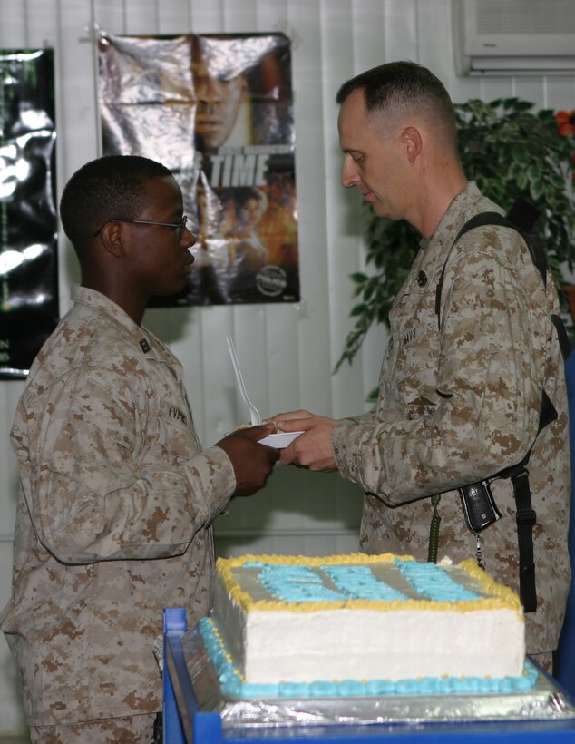 The oldest Sailor present, Chief Ronald Goforth, presented the a piece of cake to the youngest Sailor present, Seaman Darius L. Evans, signifying the passing of naval heritage to those who follow and will lead the Navy in the future,  during a cake cutting ceremony held here June 17 to honor the Navy's Hospital Corps' 107th birthday.