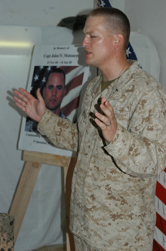 CAMP SNAKE PIT Ar Ramadi, Iraq (June 22, 2005) - Navy Lt. Aaron T. Miller, chaplain for 1st Battalion, 5th Marine Regiment delivers the meditation during a memorial service held here June 22 in honor of Capt. John W. Maloney, the late leader of Company C. Maloney, a 37-year-old from Chicopee, Mass., was killed fighting terror in the city the evening of June 16 when an improvised explosive device exploded directly underneath his Humvee. Maloney was prior enlisted and had 18 years of dedicated service the Marine Corps under his belt when he paid the ultimate price. He's survived by his wife, Michelle, and two children, Nathaniel and McKenna. Photo by: Cpl. Tom Sloan