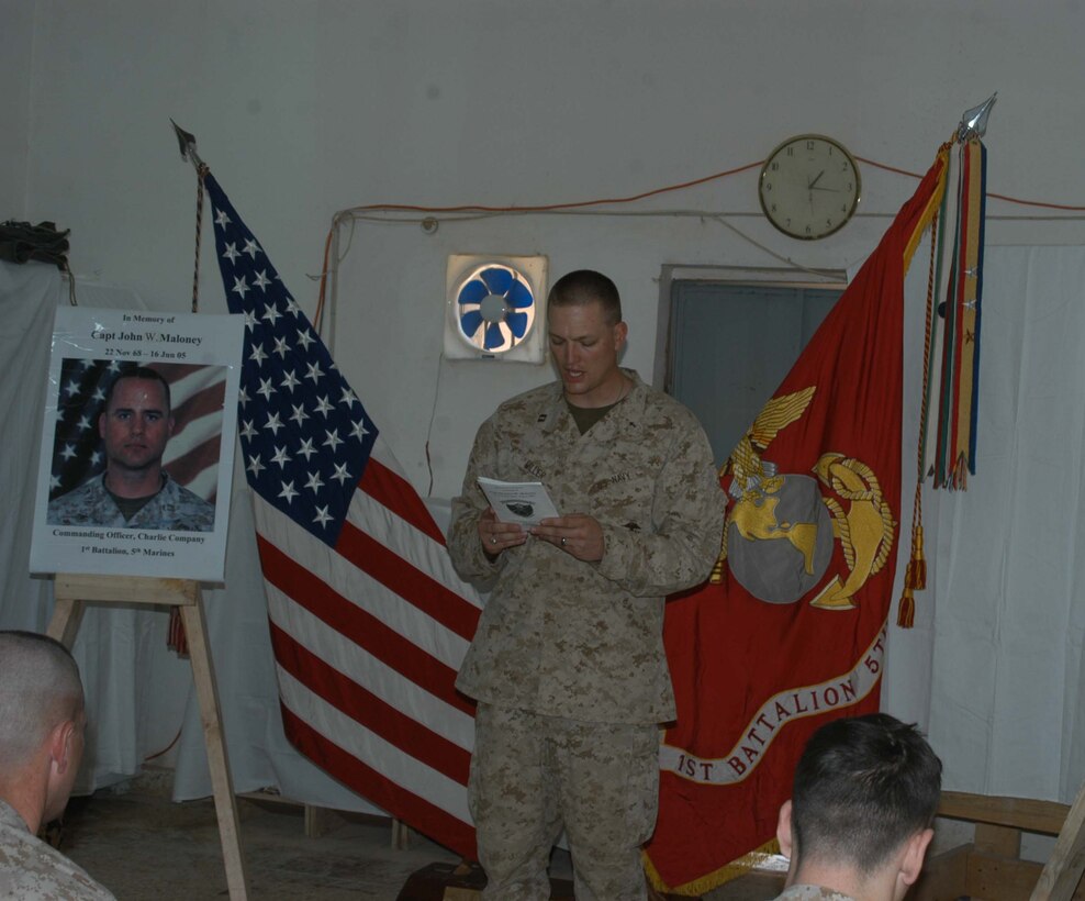 CAMP SNAKE PIT Ar Ramadi, Iraq (June 22, 2005) - Navy Lt. Aaron T. Miller, chaplain for 1st Battalion, 5th Marine Regiment delivers the meditation during a memorial service held here June 22 in honor of Capt. John W. Maloney, the late leader of Company C. Maloney, a 37-year-old from Chicopee, Mass., was killed fighting terror in the city the evening of June 16 when an improvised explosive device exploded directly underneath his Humvee. Maloney was prior enlisted and had 18 years of dedicated service the Marine Corps under his belt when he paid the ultimate price. He's survived by his wife, Michelle, and two children, Nathaniel and McKenna. Photo by: Cpl. Tom Sloan