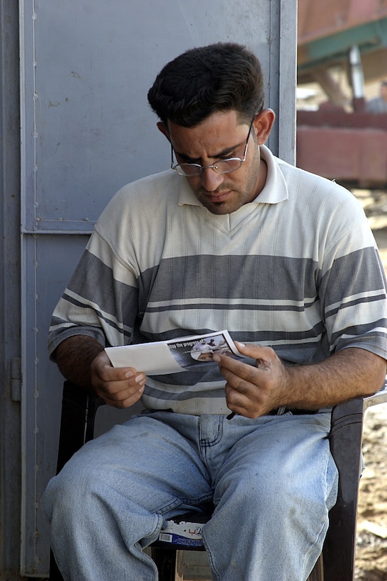 Hit, Al Anbar, Iraq (August 6, 2005)--An Iraqi man reads handbill given to him by multi-national forces. (Official USMC Photo by Lance Cpl. Shane S. Keller)