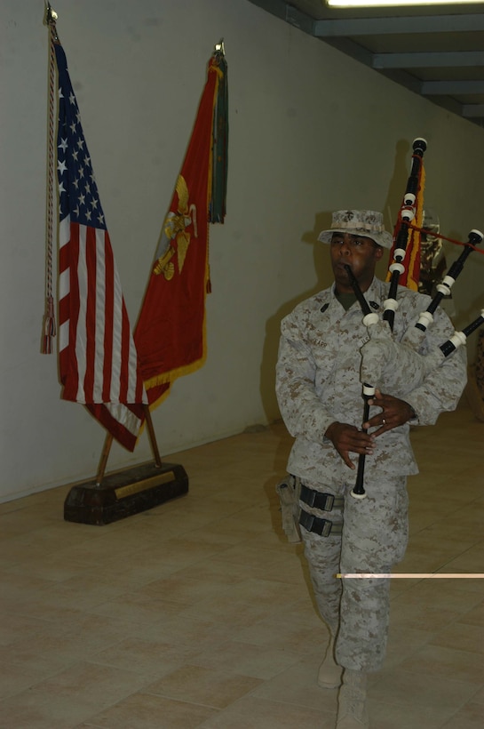 CAMP RAMADI, Ar Ramadi, Iraq (Aug. 17, 2005) - First Sergeant Dwayne W. Farr, the first sergeant for Company W, 1st Battalion, 5th Marine Regiment, marches slowly through the dining facility here Aug. 17 and plays "Amazing Grace" with his bagpipes during a memorial ceremony in honor of Staff Sgt. Ramon E. GonzalesCordova. Marines and Sailors with Camp Pendleton, Calif., -based 1st Battalion, 5th Marines mourned the loss of 31-year-old GonzalesCordova, former platoon sergeant for Company C's 2nd Platoon, who fell on Ramadi's urban battlefield Aug. 8 while fighting terror. He was from San Pedro, Honduras and leaves behind his wife, Joselyn, and son, Sergio. Photo by: Cpl. Tom Sloan