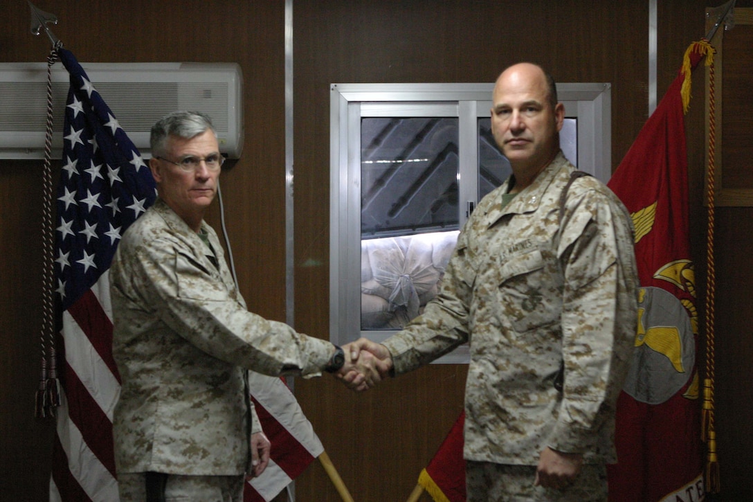 CAMP BLUE DIAMOND, RAMADI, Iraq -   Colonel Steve McKinley, seen left, commanding officer, 5th Civil Affairs Group, 2nd Marine Division shakes hands with Col. Paul W. Brier, commanding officer, 6th Civil Affairs Group, 2nd Marine Division, after a transfer of authority ceremony here. 5th CAG, the Marine Corps' first provisional civil affairs unit, has been relived by 6th CAG who will continue working with the local and provincial officials to facilitate governance and economic development in the pre-dominantly Sunni Al Anbar province. Official Marine Corps photo by Sgt Ryan S. Scranton