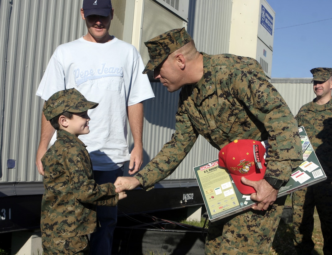 MARINE CORPS BASE CAMP LEJEUNE, N.C. - Six-year-old Brandon Rasnick shakes hands with Lt. Col. Bradley Vickers, 1st Battalion, 9th Marine Regiment's commander, outside the battalion's office here Dec. 12.  Brandon and his family visited numerous training grounds and units throughout the base while on a trip sponsored by the Make-a-Wish foundation to grant his wish of training alongside United States Marines.  Brandon is a boy from Lehigh Acres, Fla. who has cystic fibrosis, a genetic lung disorder.