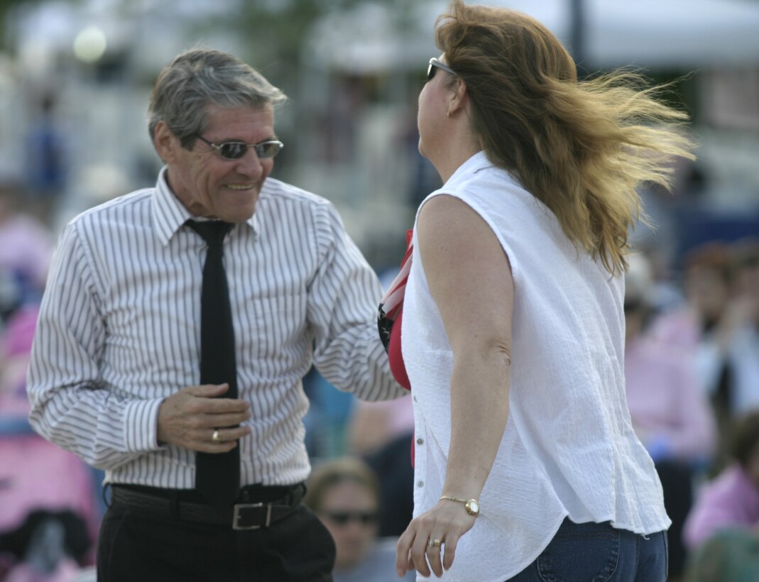 JACKSONVILLE, N.C. - Citizens in downtown Riverwalk Park here dance the evening away as musicians from the 2nd Marine Division's and 2nd Marine Aircraft Wing's bands play live music May 13.  The warriors formed an outfit unofficially called the II Marine Expeditionary Force band and entertained hundreds of local citizens with a jazz, swing and classic rock concert.