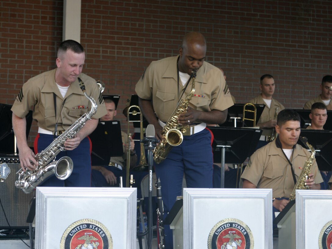 JACKSONVILLE, N.C. - Dueling saxophonists from the 2nd Marine Division's and 2nd Marine Aircraft Wing's bands boogie the evening away in downtown Riverwalk Park here May 13.  The warriors formed an outfit unofficially called the II Marine Expeditionary Force band and entertained hundreds of local citizens with a jazz, swing and classic rock concert.