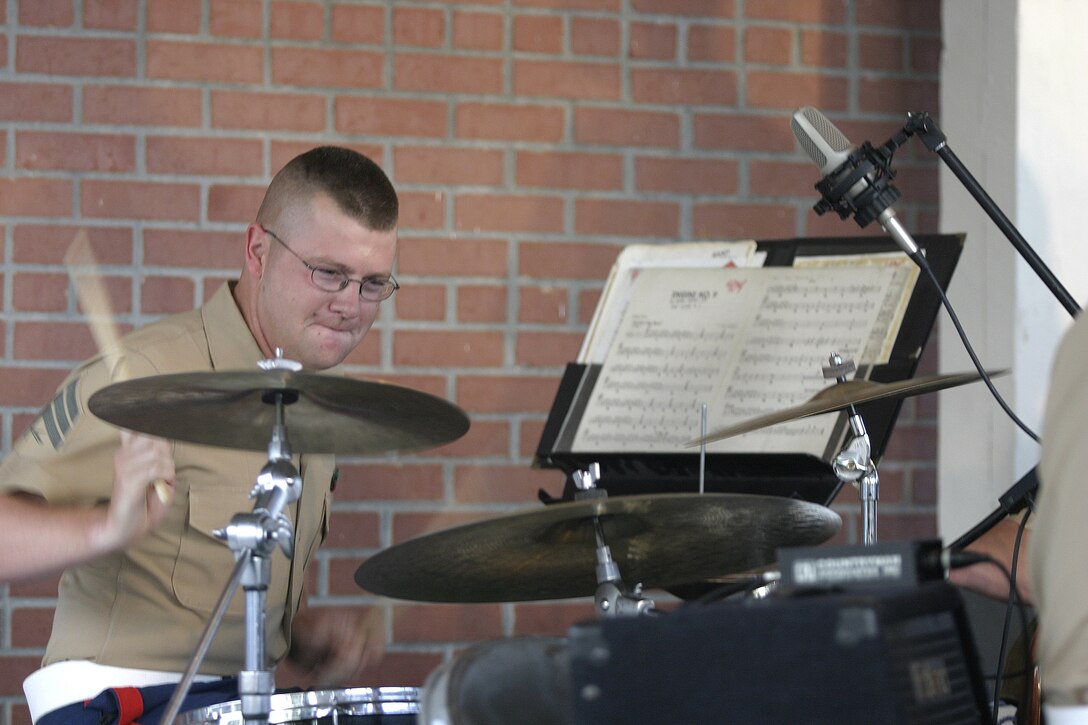 JACKSONVILLE, N.C. - A drummer pounds away at his skins as he plays alongside the 2nd Marine Division's band and the 2nd Marine Aircraft Wing's band during a performance in downtown Riverwalk Park here May 13.  The warriors formed an outfit unofficially called the II Marine Expeditionary Force band and entertained hundreds of local citizens with a jazz, swing and classic rock concert.