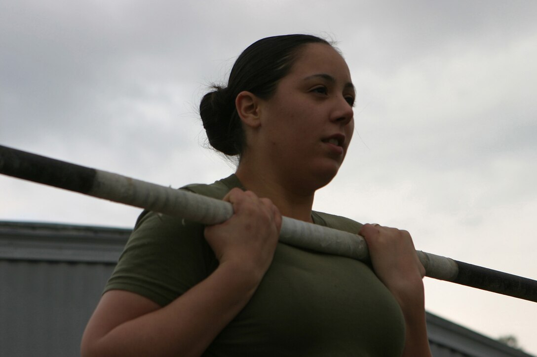 MARINE CORPS BASE CAMP LEJEUNE, N.C. (January 24, 2005) - Lance Cpl. Christiana Fowlkes, a database clerk for with Headquarters and Service Company, Headquarters Battalion, 2d Marine Division, does the flex arm hang, one of the required parts of her physical fitness test.  Official Marine Corps photo by Pfc. Terrell A. Turner released.