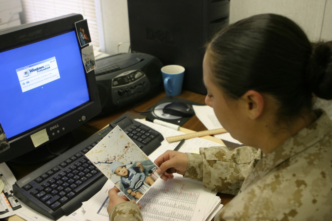 MARINE CORPS BASE CAMP LEJEUNE, N.C. (January 24, 2005) - Lance Cpl. Christiana Fowlkes, a database clerk for with Headquarters and Service Company, Headquarters Battalion, 2d Marine Division, thinks about her 11-month-old son Josiah after updating a detailed roster of everyone in the company.  Official Marine Corps photo by Pfc. Terrell A. Turner released.