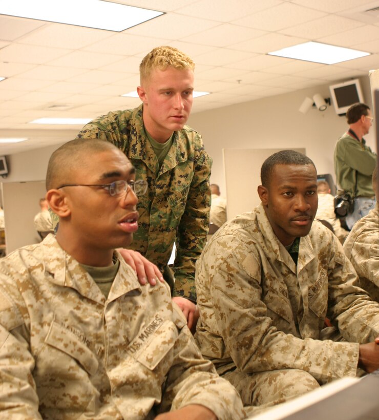 Cpl. Gary W. Hogue, a field wireman with 2nd Tank Battalion, trains Marine deploying to Iraq with computer games designed to replicate scenarios they could encounter.  The 21-year-old Saint Louis, Mo. native worked with lance corporals Jason A. Ransome, 21, of Norfolk, Va. and J.R. Okoli, 2, of Brooklyn, N.Y.  Both of the lance corporals will be deployed to Iraq before the end of March.