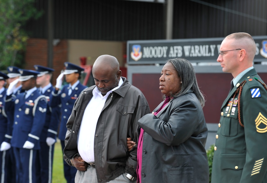 MOODY AIR FORCE BASE, Ga. -- Fred Williams Jr. and his wife, watch as their son Army Staff Sgt. Briand Williams, a fallen Soldier, is unloaded from an aircraft here. Dec. 3. “When I got the notification that my son died, I thought it was a dream,” said Mr. Williams. “I still think it’s a dream, but I know that he died serving his country.” (U.S. Air Force photo by Staff Sgt. Schelli Jones)