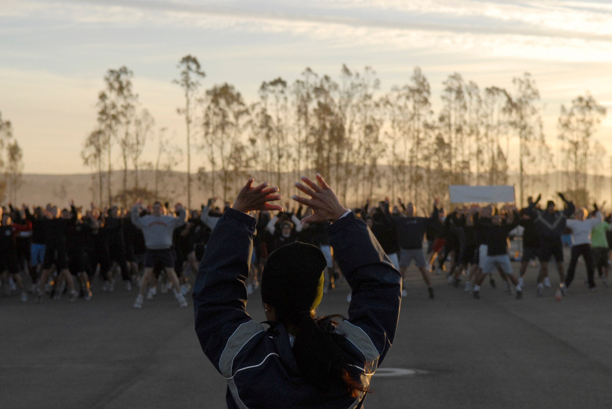 VANDENBERG AIR FORCE BASE, Calif.-- Master Sgt. Sheila White, a 30th Logistics Readiness Squadron physical training lead, begins the Wingman Day warm-up before the 10K run here Friday, Dec. 4, 2009.  The day's events were meant to promote teamwork and taking care of fellow Wingmen.  (U.S. Air Force photo/Senior Airman Andrew Satran)