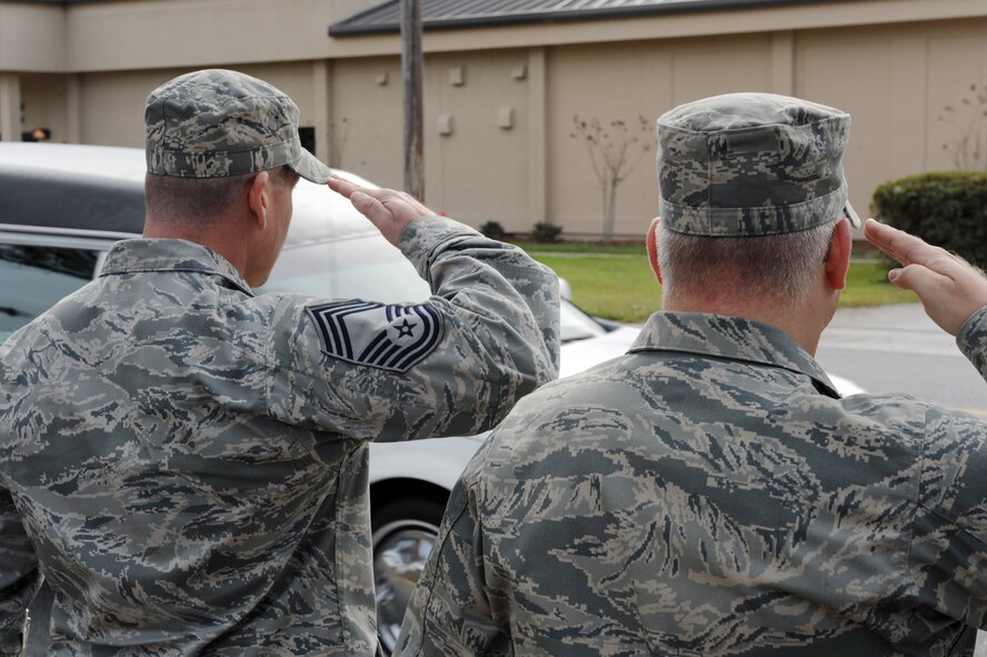 MOODY AIR FORCE BASE, Ga. -- Airmen from the 23rd Wing pay the proper respects as a hearse travels down Robbins Road here Dec. 3. The hearse carried Army Staff Sgt Briand Williams, a fallen Soldier who was stationed at Fort Benning, Ga. (U.S. Air Force photo by Airman 1st Class Benjamin Wiseman)
