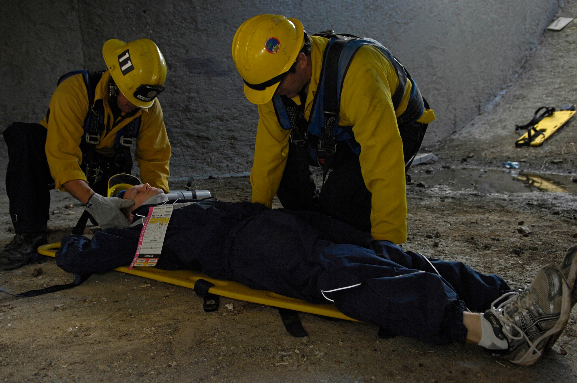 VANDENBERG AIR FORCE BASE, Calif. -- Firefighters George Georgas, from the Santa Barbara County Department and Mathew Stevens, a Vandenberg fire fighter, quickly prepares an injured survivor for evacuation during a building collapse exercise here Monday, Nov. 30, 2009. (U.S. Air Force photo/Airman 1st Class Andrew Lee) 

 

 