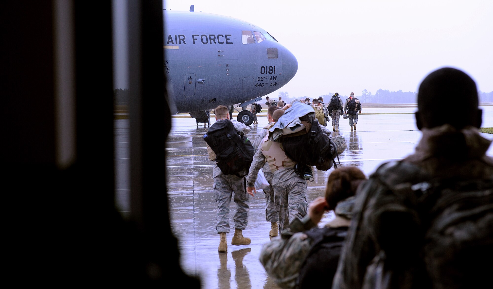MOODY AIR FORCE BASE, Ga. -- Airmen from the 23rd Wing walk out to the flightline to board a C-17 Globemaster III here prior to leaving for a deployment here to Dec. 2. The Airmen are deploying for about 6 months.  (U.S. Air Force photo by Airman 1st Class Joshua Green)