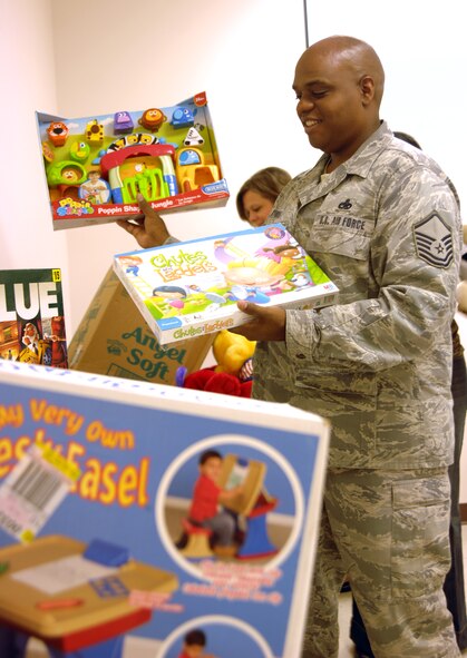 MOODY AIR FORCE BASE, Ga. -- Master Sgt. Stanley Byron, 23rd Force Support Squadron Airman and Family Readiness Center readiness NCO, helps sort gifts at the A&FRC here Dec. 2. Donated through the Angel Tree project, the gifts will be distributed to children of Moody members in need this holiday season. (U.S. Air Force photo by Airman 1st Class Brigitte Brantley)