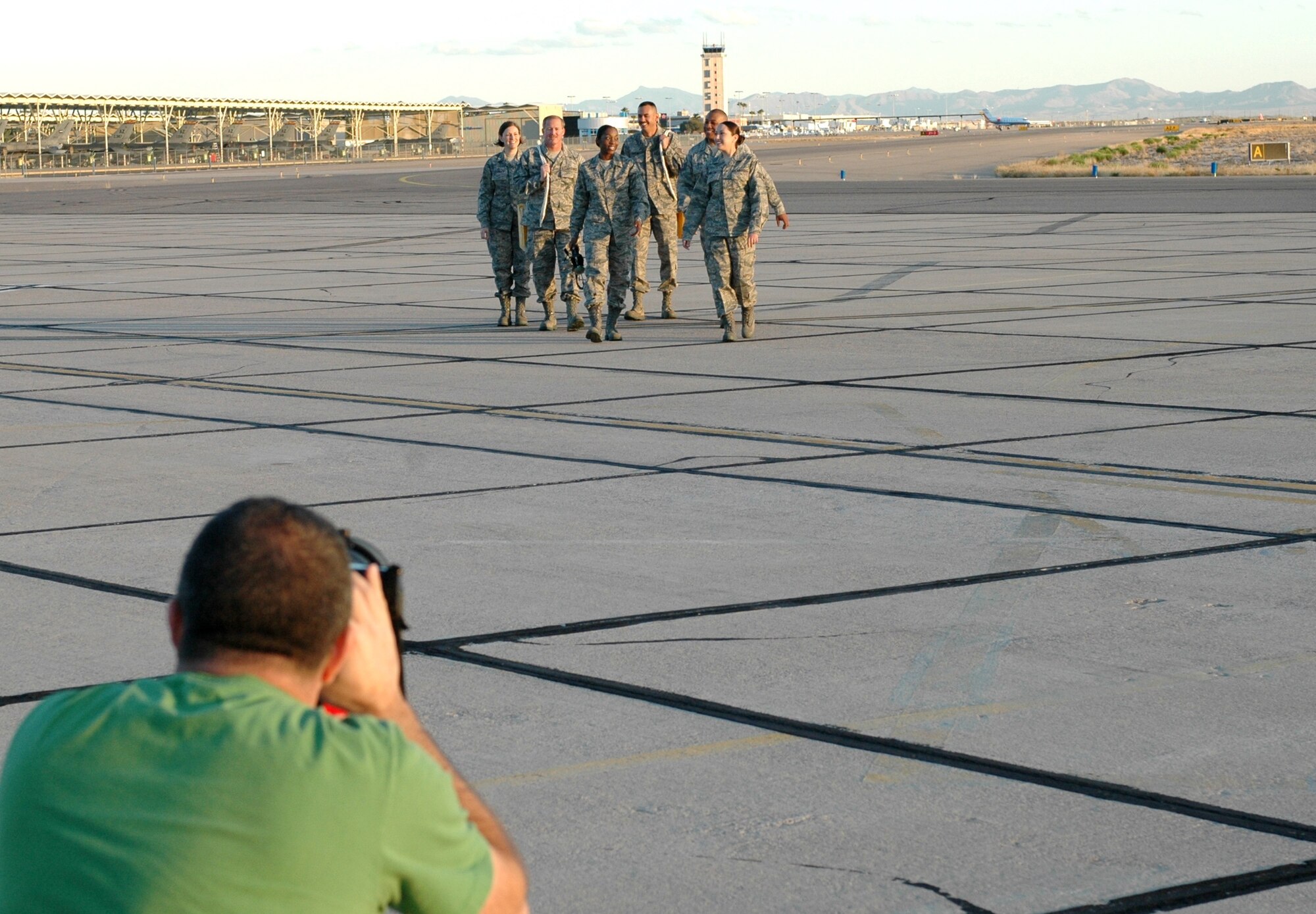 ANG Creative Team photographer Rob Trubia takes photographs of 162nd Fighter Wing members at Tucson International Airport, Dec 3. (From the left) Staff Sgt. Brandy Guzman, Tech. Sgt. Bruce Newcomb, Staff Sgt. Erin Peters, Staff Sgt. Mark Catlin, Master Sgt. Gary Jack and Staff Sgt. Robin Hinton were among 20 unit members featured in the four-day photo shoot. The images will be used in brochures intended to attract recruits with prior active duty military experience. (Air Force photo by Maj. Gabe Johnson)
