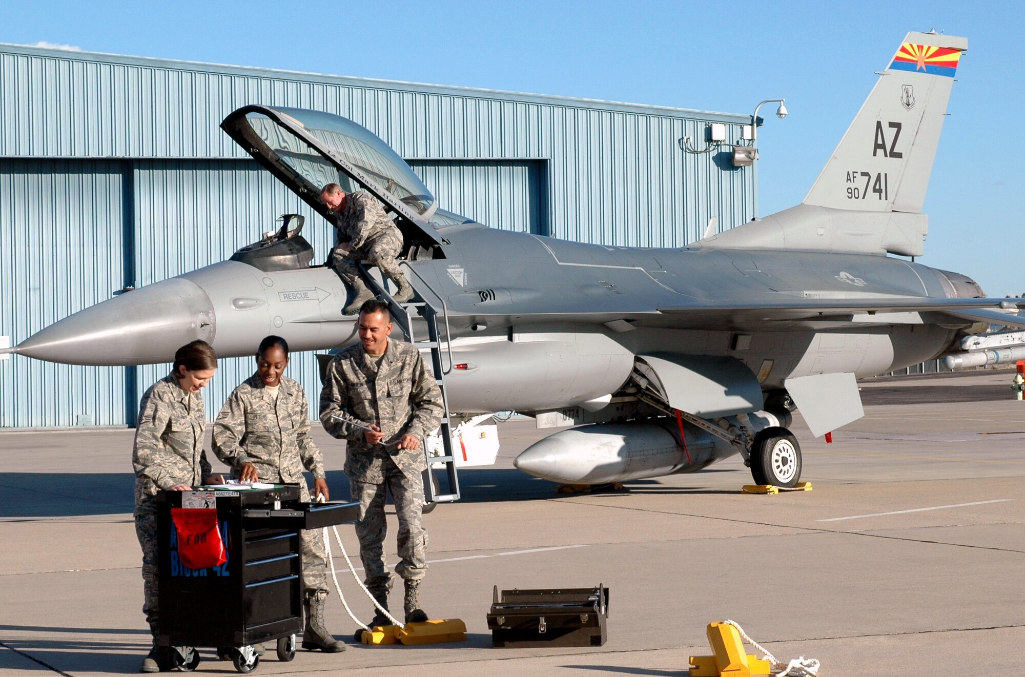 Staff Sgt. Brandy Guzman, left, Staff Sgt. Erin Peters, Staff Sgt. Mark Catlin and Tech. Sgt. Bruce Newcomb pose for ANG Creative Team cameras on the flightline at Tucson International Airport, Dec. 3.  The photos will be used in brochures intended to attract recruits with prior active duty military experience. (Air Force photo by Maj. Gabe Johnson)