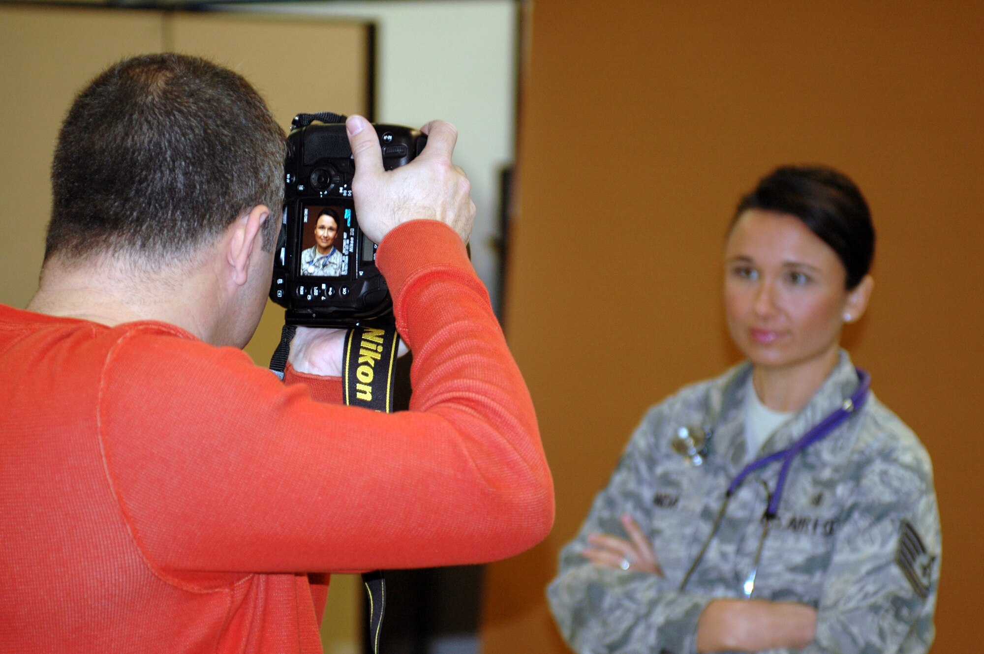 ANG Creative Team photographer Rob Trubia takes portrait photographs of Tech. Sgt. Cally Handa from the 162nd Medical Group Dec.2 for a national Air Guard recruiting campaign set to launch in February 2010. The photos will be used in brochures intended to attract recruits with prior active duty military experience. (Air Force photo by Maj. Gabe Johnson)