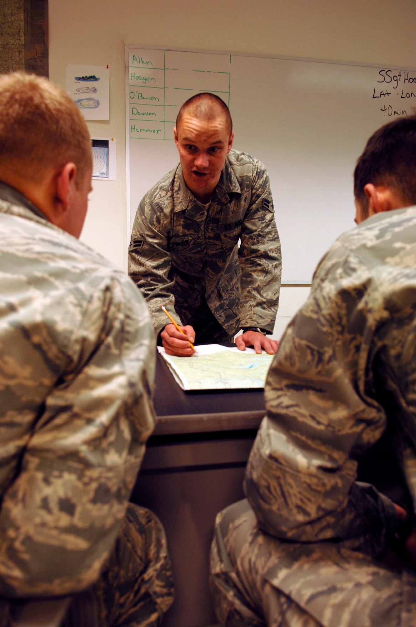 Airman 1st Class Antony Pinque, SERE student, practices giving a lesson on map reading as other students look on. (U.S. Air Force photo/Senior Airman Emerald Ralston)