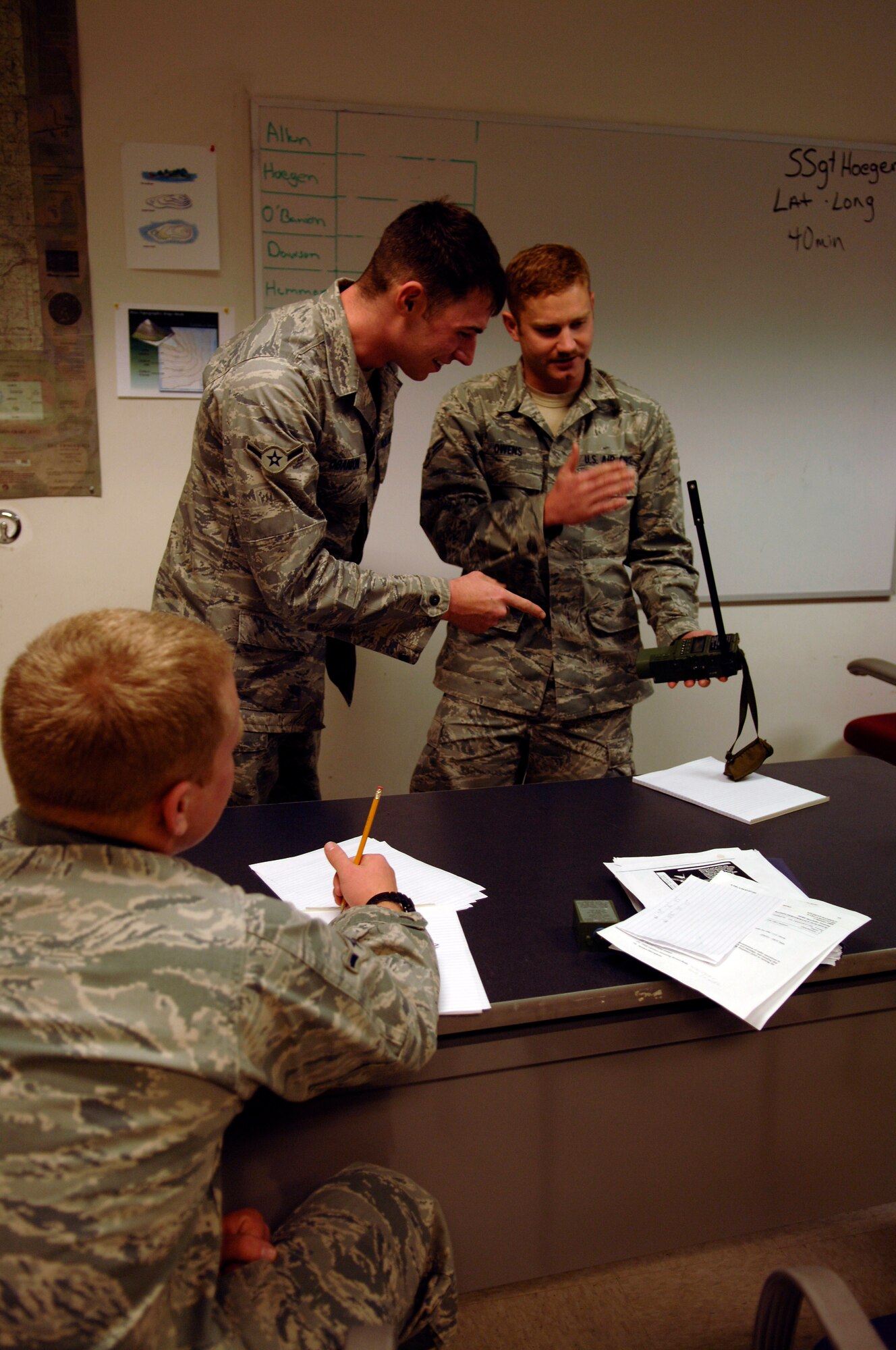 Airman 1st Class David Owens, SERE student, practices giving a lesson on radio usage while other SERE students look on. (U.S. Air Force photo/Senior Airman Emerald Ralston)