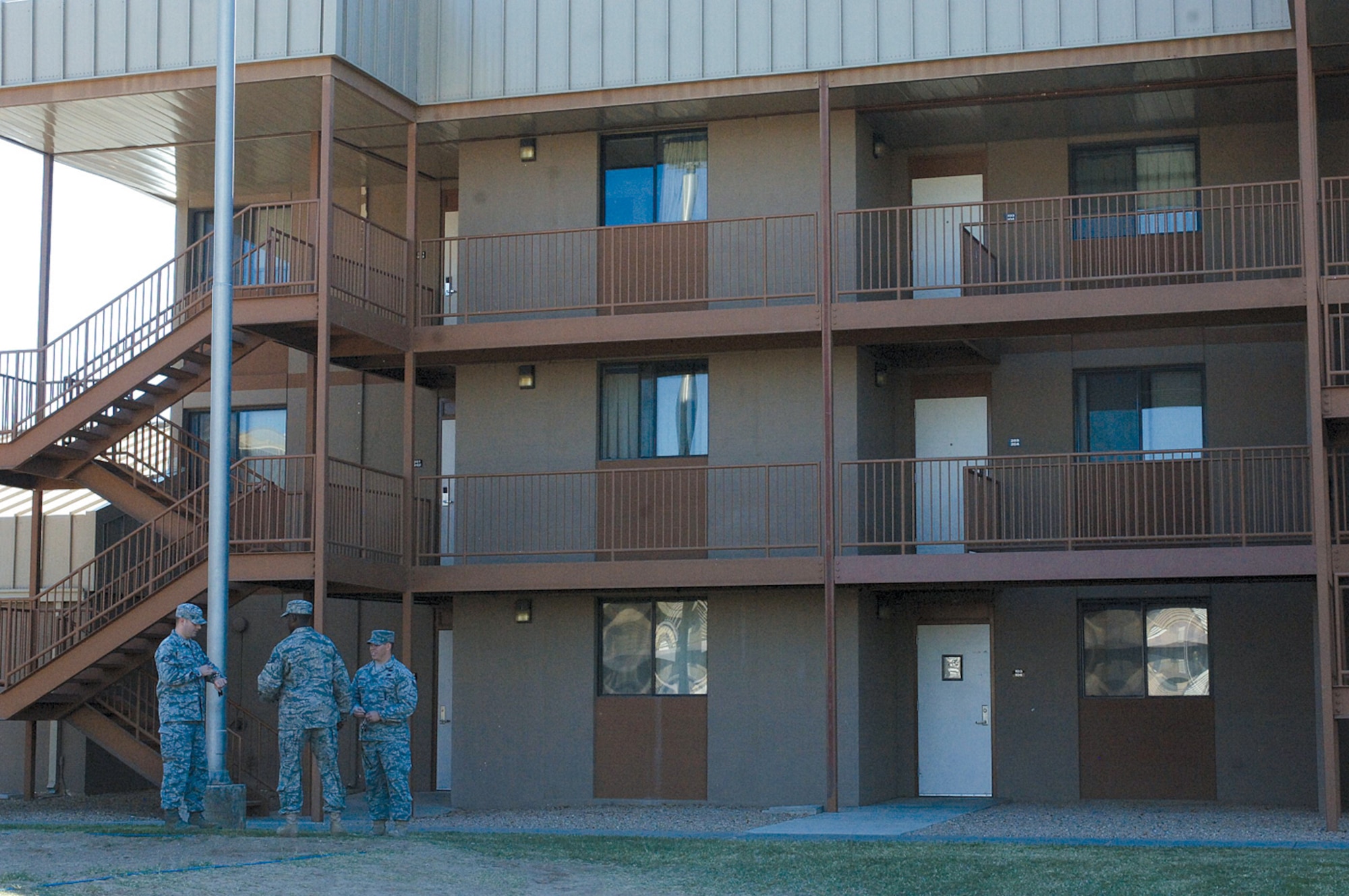 Staff Sgts. Kevin Zois, Leon Russell and Zachary Hildebrand, 56th Civil Engineer Squadron dorm managers, chat outside at Luke Air Force Base. Four dorms managers oversee the 11 dorms on base which houses 780 Airmen. (U.S. Air Force photo by Deborah Silliman Wolfe)