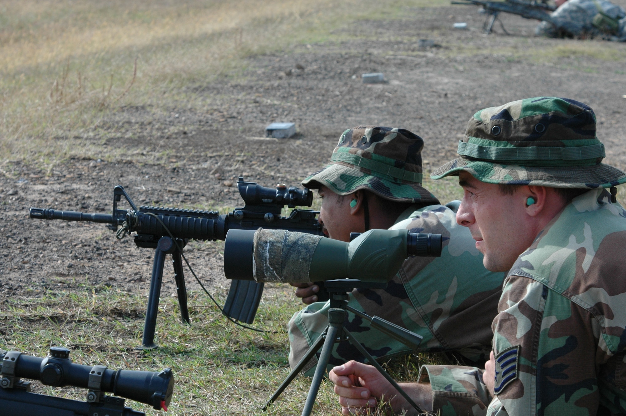 615th Contingency Response Wing sniper team member Staff Sgt. John Patnaude, 570th Global Mobility Readiness Squadron, spots targets for his shooter Senior Airman Michael Blake, 572nd Global Mobility Readiness Squadron, during a joint sniper competition.  