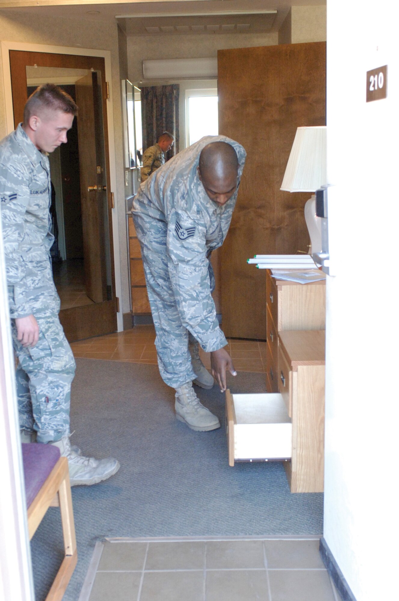 Staff  Sgt. Leon Russell, 56th Civil Engineer Squadron dorm manager, conducts a dorm room inspection for an Airman moving out at Luke Air Force Base. (U.S. Air Force photo by Deborah Silliman Wolfe) 