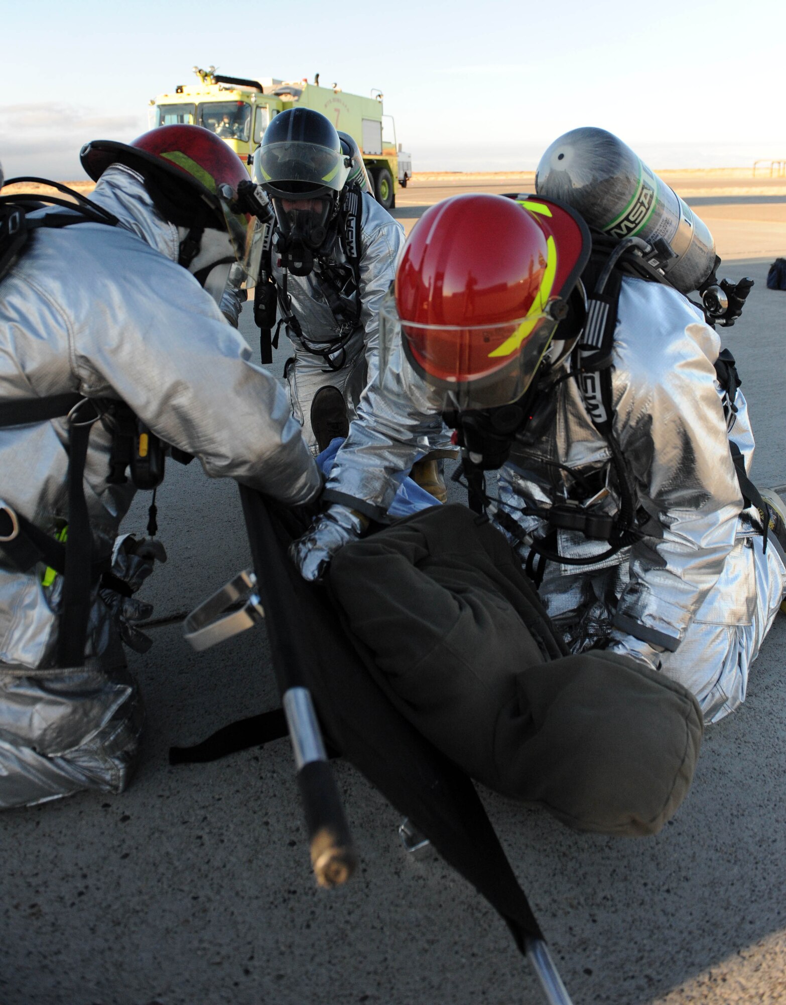 MOUNTAIN HOME AIR FORCE BASE, Idaho -- Firefighters from the 366th Civil Engineer Squadron fire protection flight unfold a litter as they prepare to carry Airman 1st Class Jacob Loper, 366th Component Maintenance Squadron precision measurement equipment flight technician, as he simulates being injured in a simulated C-17 Globemaster crash during an emergency management exercise Dec. 2. The 366th Fighter Wing conducts exercises to prepare first responders and wing personnel for a variety of possible emergencies and accidents. (U.S. Air Force photo by Airman 1st Class Debbie Lockhart)