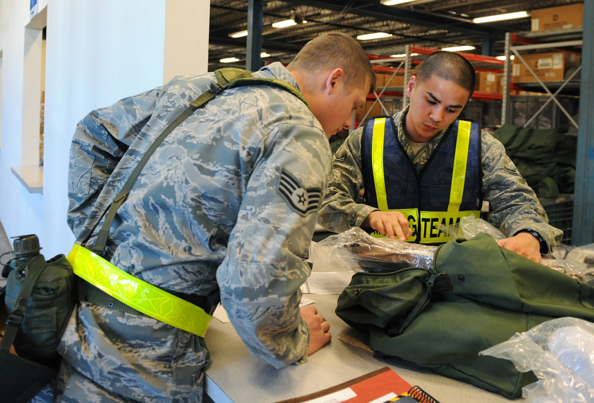 LANGLEY AIR FORCE BASE, Va. - Airman 1st Class John Anny, 1st Logistics Readiness Squadron Supply apprentice, issues mobility supplies to Staff Sgt. Russell Greer, 1st Component Maintenance Squadron Precision Measurement Equipment Laboratory craftsman, during a Phase I Operational Readiness Exercise Dec. 3. Wing Exercise Evaluation Team members will assess the ability of 1st Fighter Wing units to deploy cargo, aircraft and Airmen within a limited timeframe.(U.S. Air Force photo/Airman 1st Class Gul Crockett)