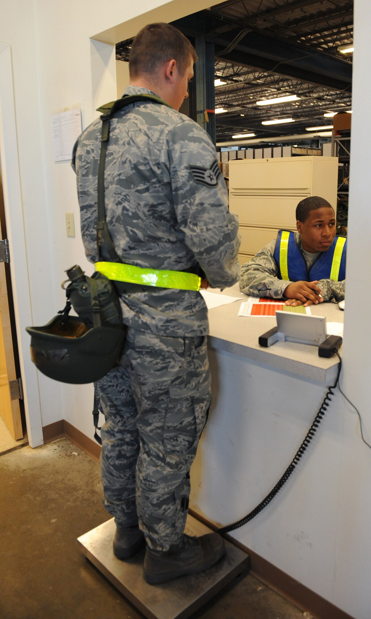 LANGLEY AIR FORCE BASE, Va. - Senior Airman Akino Malcum, 1st Logistics Readiness Squadron Traffic Management journeyman, weighs Staff Sgt. Russell Greer, 1st Component Maintenance Squadron Precision Measurement Equipment Laboratory craftsman, to ensure total passenger weight does not exceed the aircraft’s capacity, during a Phase I Operational Readiness Exercise Dec. 3. Wing Exercise Evaluation Team members will assess the ability of 1st Fighter Wing units to deploy cargo, aircraft and Airmen within a limited timeframe. (U.S. Air Force photo/Airman 1st Class Gul Crockett)
