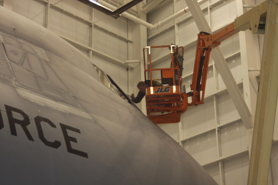 WRIGHT-PATTERSON AIR FORCE BASE, Ohio – Staff Sgt. Mike Benzing, 445th Aircraft Maintenance Squadron crew chief, does some repair work around the nose of a C-5 Galaxy aircraft during an isochronal inspection Nov. 12.  ISO inspections are thorough examinations of the entire aircraft where aircraft maintainers look for and repair problems in every system, from nose to tail and wingtip to wingtip. (U.S. Air Force photo/Stacy Vaughn)