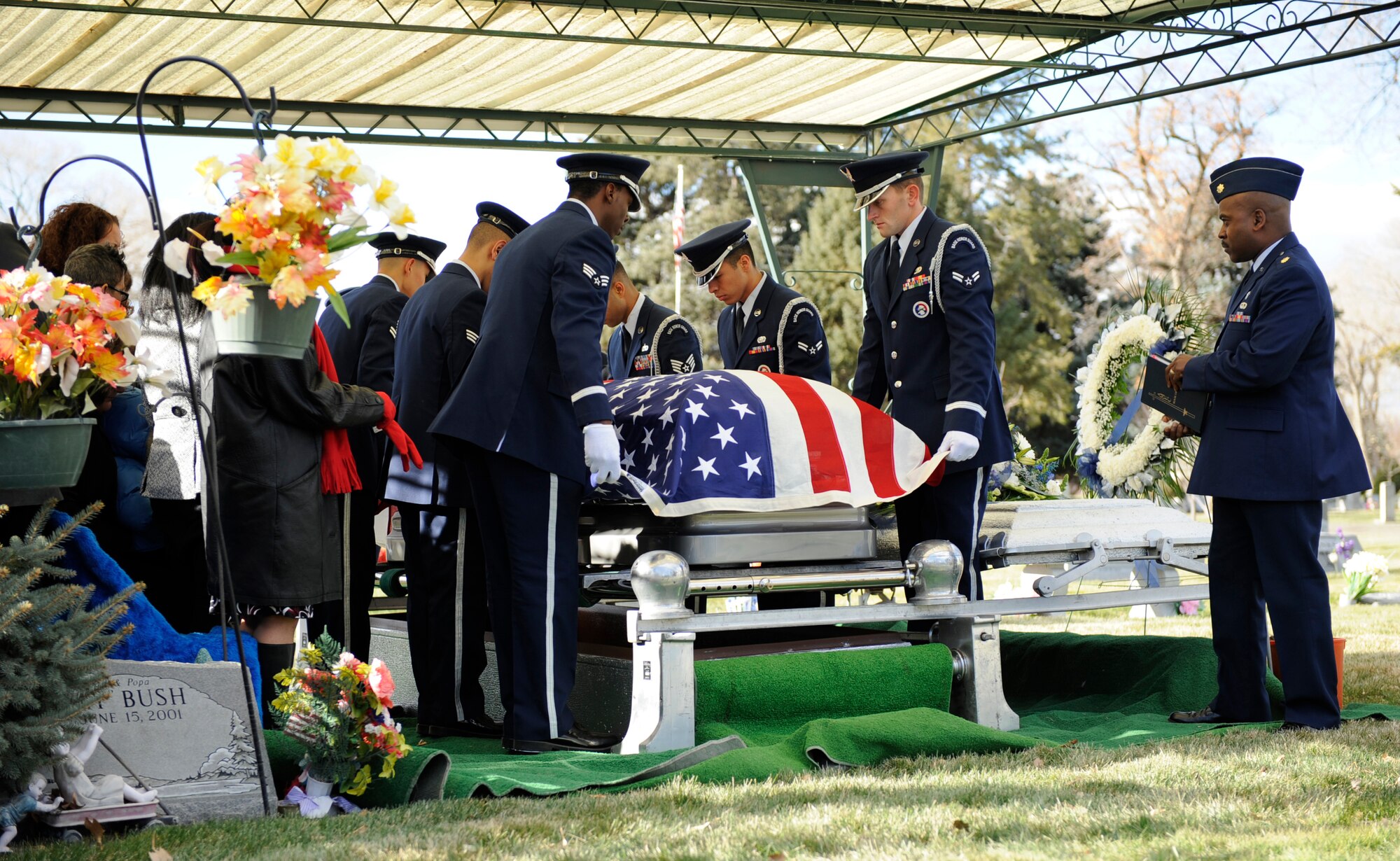 MOUNTAIN HOME AIR FORCE BASE, Idaho -- Honor guard members prepare to fold a flag over Tech. Sgt. Damon Robinson's casket during a memorial service held in Mountain View cemetery Nov. 21. Sergeant Robinson was assigned to the 366th Aircraft Maintenance Squadron and passed away Nov. 15. (U.S. Air Force photo by Airman 1st Class Renishia Richardson)