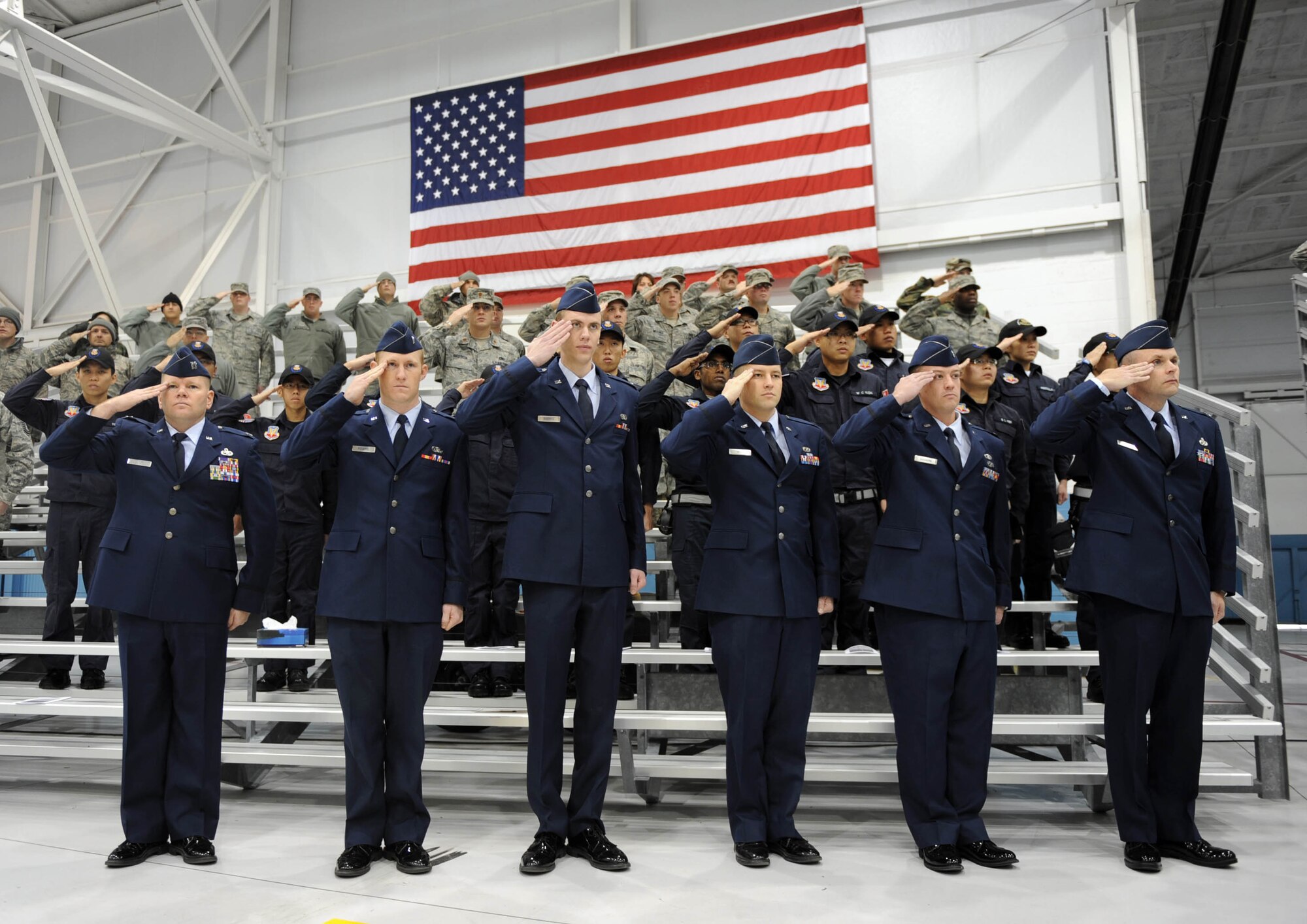 MOUNTAIN HOME AIR FORCE BASE, Idaho -- Airmen from the 366th Fighter Wing salute as taps plays during a memorial service in honor of tech. Sgt. Damon Robinson Nov. 20. Sergeant Robinson was assigned to the 366th Aircraft Maintenance Squadron and passed away Nov. 15. (U.S. Air Force photo by Airman 1st Class Debbie Lockhart)