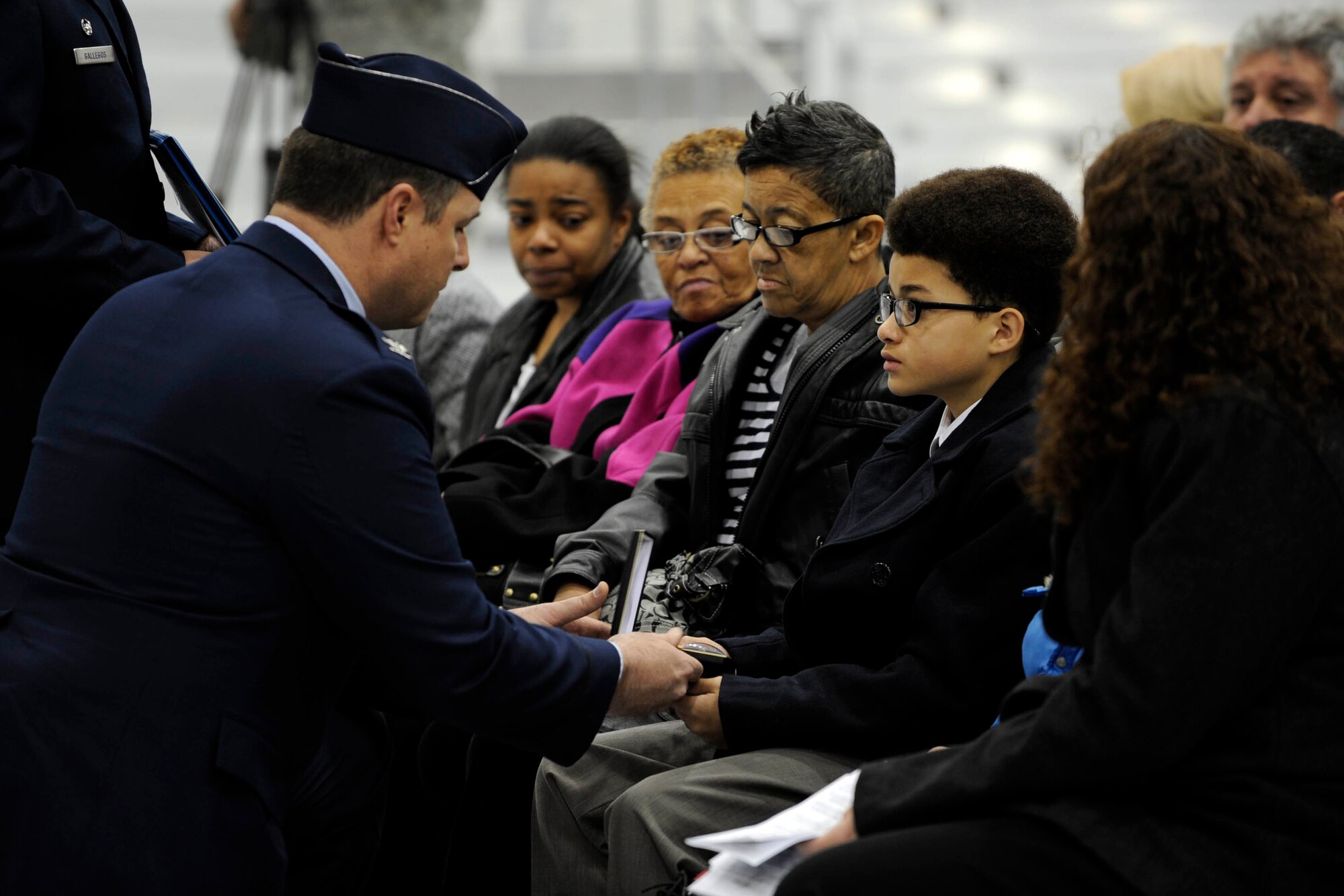 MOUNTAIN HOME AIR FORCE BASE, Idaho -- Col. John Bird, 366th Fighter Wing commander, presents an Air Force Achievement Medal to tech. Sgt. Damon Robinson's son during a memorial service Nov. 20. Sergeant Robinson was assigned to the 366th Aircraft Maintenance Squadron and passed away Nov. 15. (U.S. Air Force photo by Airman 1st Class Debbie Lockhart)