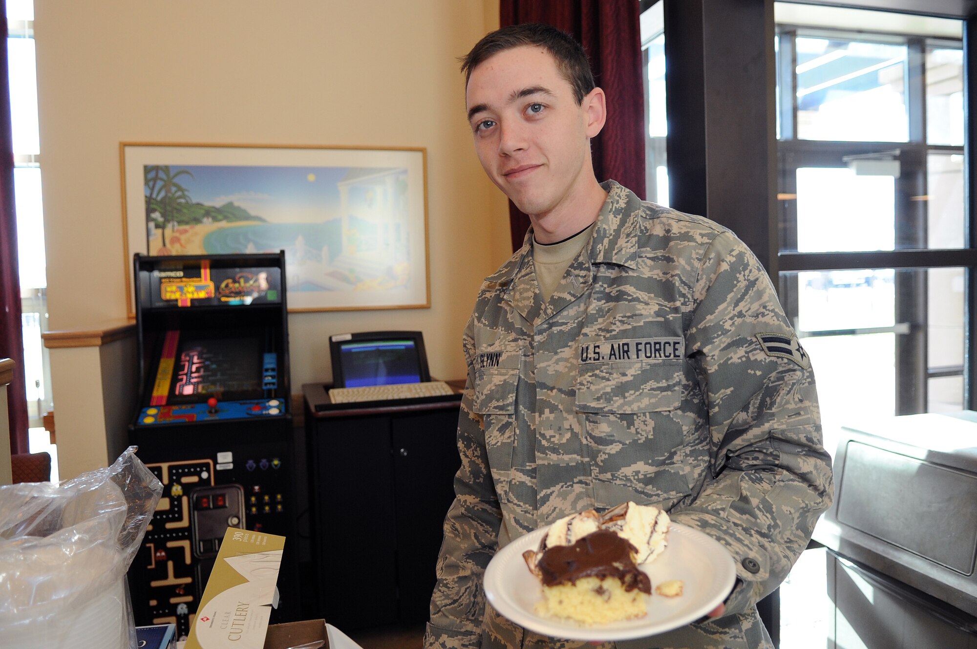 BUCKLEY AIR FORCE BASE, Colo.-- Airman 1st Class Kevin Glynn serves himself desert during the Dorm Thanksgiving event Nov 25. Airman Glynn is a resident at the Buckley dorms. ( U.S. Air Force photo by Airman 1st Class Marcy Glass )