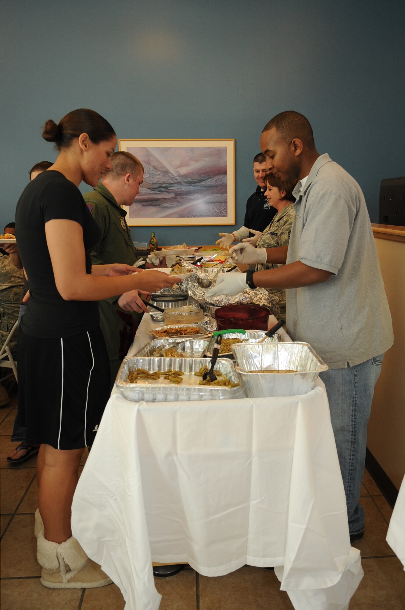 BUCKLEY AIR FORCE BASE, Colo.--  A number of volunteers dish out food to dorm residents Nov 25. Buckley's 5/6 Council hosted this year's Thanksgiving Day Dorm Dinner. ( U.S. Air Force photo by Airman 1st Class Marcy Glass )