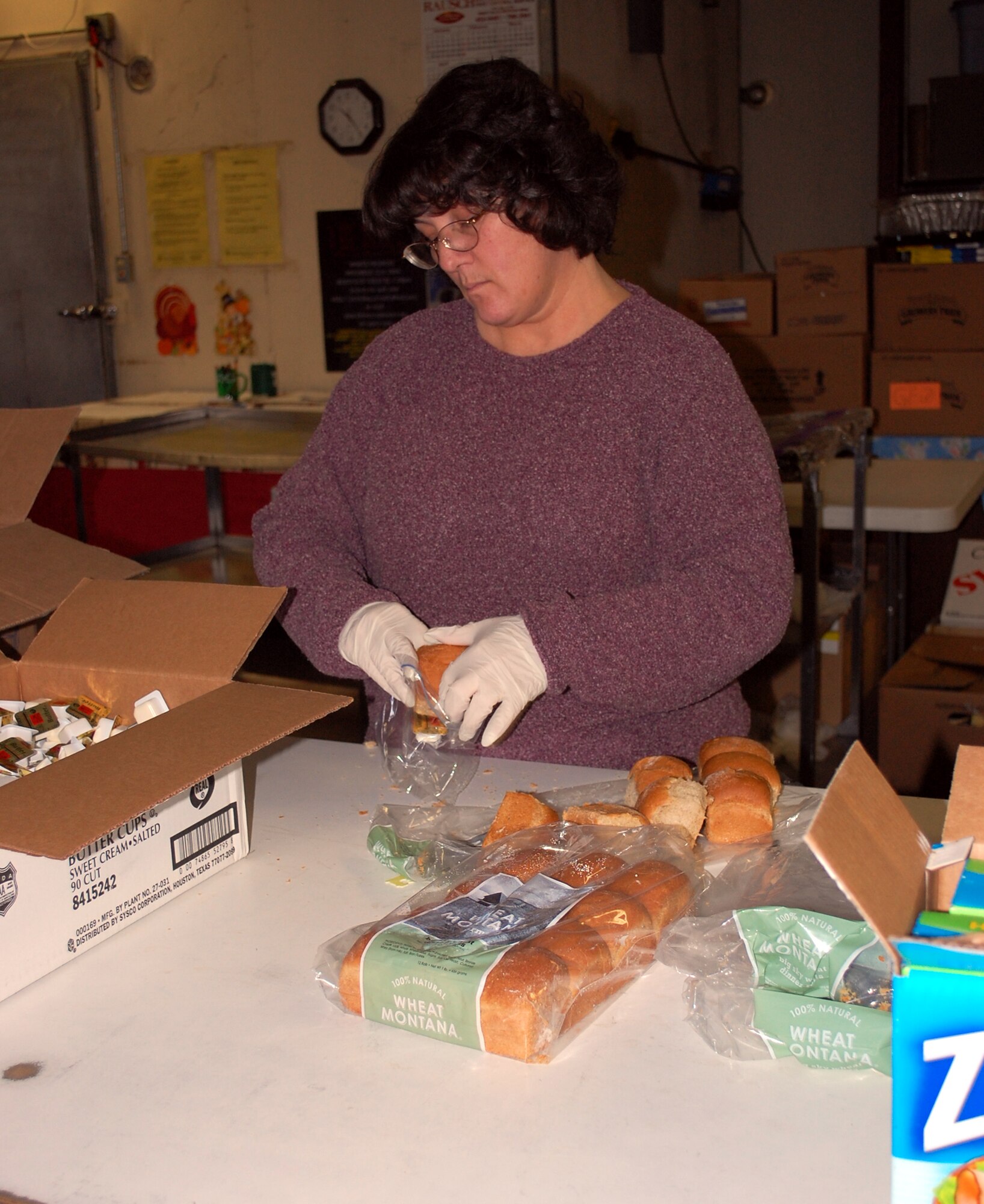 Victoria Plank packages bread rolls and butter Nov. 25 at the Meals-on-Wheels kitchen in preparation for the 371 deliveries scheduled to be made Thanksgiving day. Ms. Plank is the base formal training manager with the 341st Force Support Squadron. (U.S. Air Force photo/Valerie Mullett)