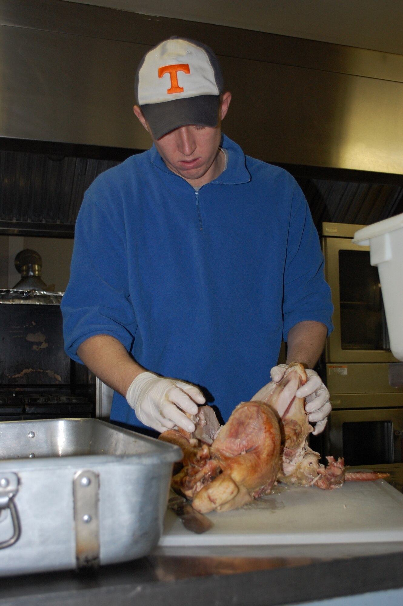 Airman 1st Class Anel Mehmedovic, 341st Force Support Squadron, debones a turkey at the Meals-on-Wheels kitchen Nov. 25. A total of 23 turkeys were prepped the day prior to be used in the more than 370 meals dished up for delivery to local area seniors on Thanksgiving day. (U.S. Air Force photo/Valerie Mullett)