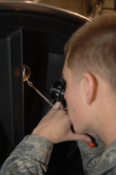 Airman 1st Class Brandon Williams, 509th Maintenance Squadron Aerospace Propulsion Apprentice, performs an engine inlet inspection on a B-2 engine.  The engine must be inspected after removal and before installation.  The engine was removed to access a damaged tail pipe.   (U.S. Air Force photo by Senior Airman Jessica Mae Snow) (Released)