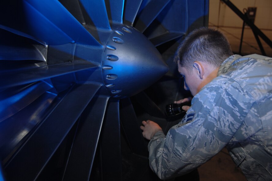 Airman 1st Class Brandon Williams, 509th Maintenance Squadron Aerospace Propulsion Apprentice, performs an engine inlet inspection on a B-2 engine.  The engine must be inspected after removal and before installation.  The engine was removed to access a damaged tail pipe.  (U.S. Air Force photo by Senior Airman Jessica Mae Snow)