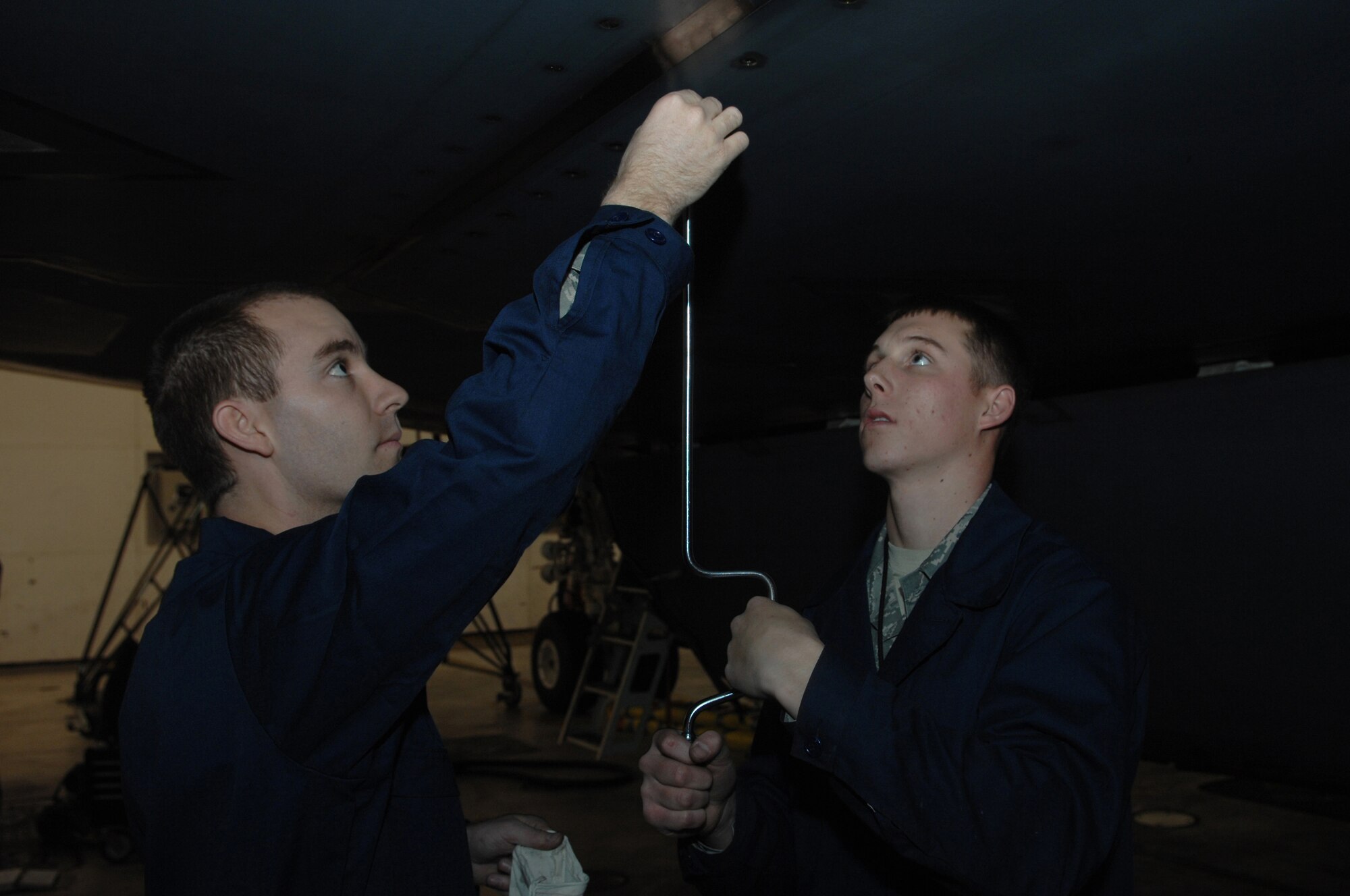 Airman 1st Class Adam Foster and Brandon Williams, 509th Maintenance Squadron Aerospace Propulsion Apprentices, remove a panel to access a damaged B-2 tail pipe. The Propulsion flight keeps all B-2 engines in prime operational condition.  They also diagnose problems in the engine systems such as the fuel system, oil system, electrical system and the engine airflow system.  The team installs serviceable components, test runs repaired engines in the aircraft or test cell, diagnose engine problems and perform engine checks.(U.S. Air Force photo by Senior Airman Jessica Mae Snow) (Released)